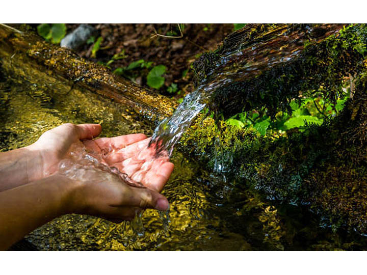 photo of spring water pouring into hands